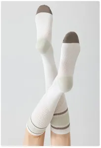 Breathable athletic compression socks for women, long white sports socks for running fitness hiking.