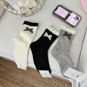 Women's cute polka dot mid-tube socks with elegant bows, breathable cotton spring summer style.