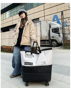 Large capacity rolling travel duffel bag with wheels, stylish color block weekender bag.