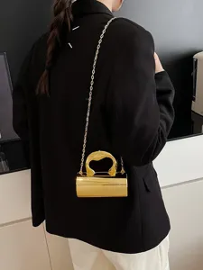 Glossy PVC cylinder crossbody bag for women, luxury style metallic chain handbag with gold handle.