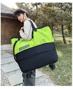Oversized 73L color-blocked rolling travel duffel bag with shoulder strap for outdoor fitness.