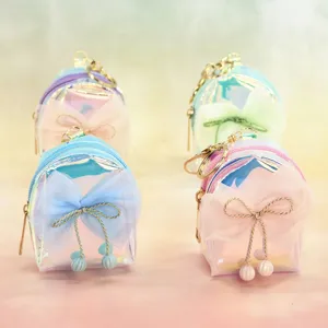 Holographic mini backpack keychain with cute mesh bow, stylish coin purse accessory for bags.