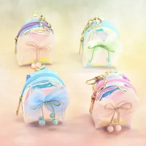 Holographic mini backpack coin purse featuring cute mesh bows and shiny keychain charms.
