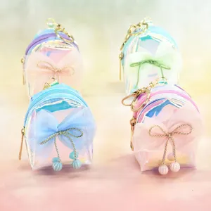 Detail shot of holographic mini backpack keychain featuring cute mesh bow and pearl charms.