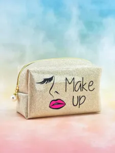 Glitter sequin makeup bag detail view, featuring stylish face graphic and pearl zipper pull.