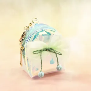 Holographic mini backpack keychain coin purse with cute mesh bow and beaded tassel decor.