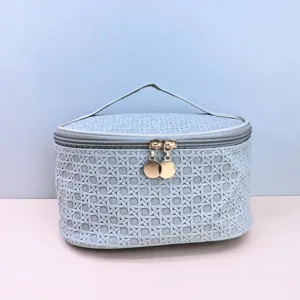 Detail view of the portable travel PU cosmetic bag in light blue, featuring a top handle and zip.