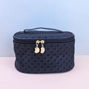 Black woven PU cosmetic bag detail showcasing premium texture, sturdy handle, and gold zippers.
