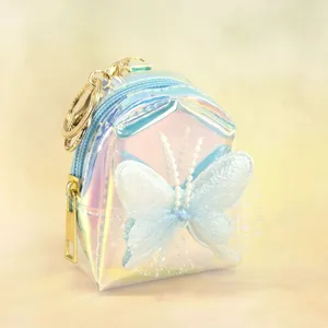Mini iridescent holographic coin purse keychain with blue butterfly and gold hardware variant.