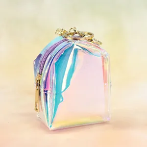 Detail shot of mini transparent holographic backpack keychain with purple zipper and gold hardware.