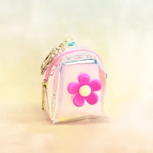 Holographic mini backpack coin purse detail, shiny clear pouch with cute pink flower charm.