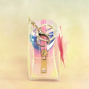 Holographic clear mini coin purse detail view showcasing gold keychain and pink bow charm.