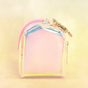 Close-up detail of the holographic pink mini backpack coin purse featuring a golden keychain.