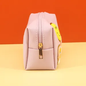 Pink makeup bag with cute smiley face patch, portable cosmetic storage pouch for women.
