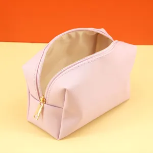 Compact pink cosmetic bag with gold zipper, stylish travel makeup organizer for daily use.