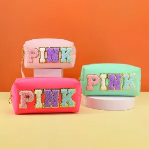 Detailed view of the cosmetic pouch with chenille letter patch, stylish storage design.