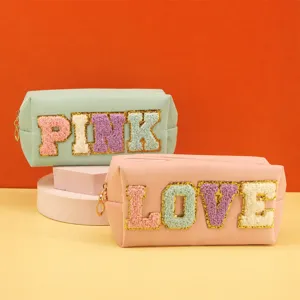 Stylish cosmetic bag with letter patches, PU leather portable zipper makeup pouch for women.