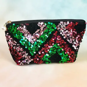 Detailed view of the sparkling sequin cosmetic bag with chevron pattern and pearl zipper charm.