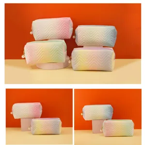 Gradient quilted cosmetic bag with pearl zipper, stylish large capacity makeup pouch.
