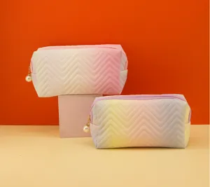 Gradient quilted cosmetic bag with pearl zipper, stylish large capacity makeup storage pouch.