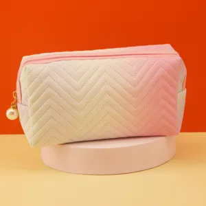 Pastel gradient cosmetic bag with chevron quilting and pearl zipper pull, elegant storage clutch.