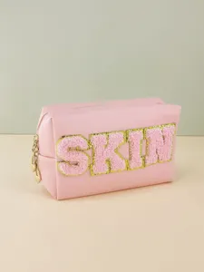 Pink PU leather cosmetic makeup bag with fuzzy chenille letter patch SKIN and zip.