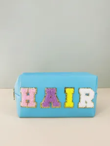 Blue PU leather cosmetic bag with colorful chenille letter patch HAIR detail close up display