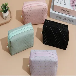 Corduroy cosmetic bag detail, gold glitter polka dots, elegant pearl zipper pull, multi-color storage.
