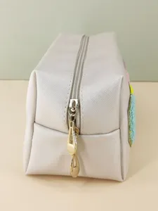 Close-up detail of the durable metal zipper and smooth PU leather texture of this cosmetic bag.