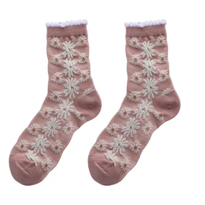Cute pink mid-calf socks featuring adorable white daisy patterns and stylish ruffled cuffs for women.