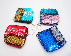 Close-up of colorful sequin coin purses with keychains, detail view of sparkling mini bags.