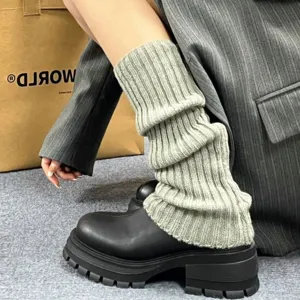 Grey knitted leg warmers for women, cozy winter slouch socks paired with chunky boots outfit.