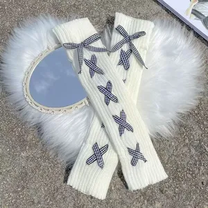 White knitted leg warmers with black plaid bows, cute JK style long slouch socks for winter.