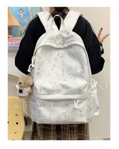 Back view of white lightning print backpack with marble texture on student model