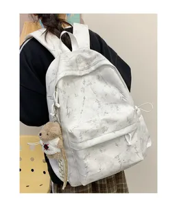 Detailed macro view of white lightning pattern backpack with cute bear plush charm