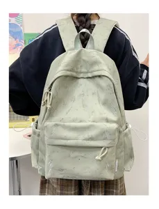 Detailed rear view of light green backpack with lightning pattern worn by model