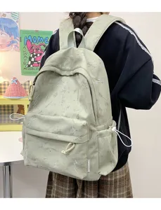 Sage green large capacity backpack with lightning embroidery shown on a model