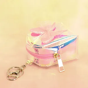 Holographic mini coin purse close up, cute pink butterfly bow keychain pendant detail.