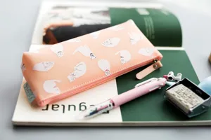 Cute pink silicone pencil case with cat patterns, soft and durable stationery storage bag for students.