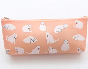 Close-up detail of pink silicone pencil case featuring cute white cartoon cat prints.