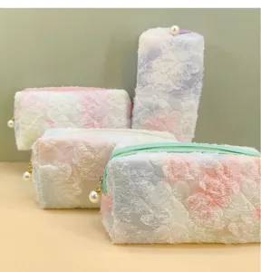 Close-up detail of fluffy tie-dye cosmetic bag showcasing soft texture and pearl zipper.