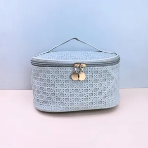 Large capacity PU woven cosmetic bag with double zipper and handle for travel and storage.