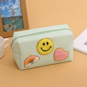 Green cosmetic bag with cute smiley face embroidery, practical makeup storage pouch for women.
