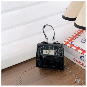 Detailed view of black patent leather mini Kelly handbag featuring crocodile texture and silver turn-lock.
