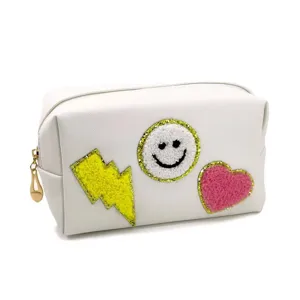 White cosmetic bag with cute patch embroidery, PU leather makeup pouch for travel and daily use.