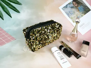 Detailed view of glittering sequin cosmetic bag with gold sequins, perfect travel storage.