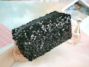 Detailed view of the black sequin cosmetic bag, featuring shimmering sequins and metal ring pull.