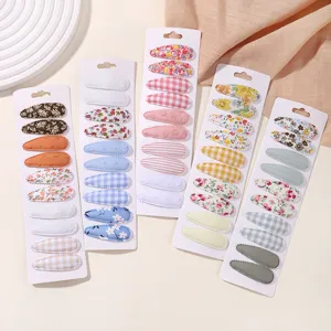 Detailed view of 50-piece set floral and plaid fabric-covered teardrop hair clips