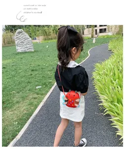 Cute cartoon ladybug children crossbody bag outdoor scene detail showing red mini design.