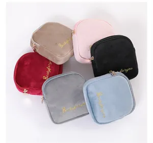 Velvet zipper pouch detail view showing multiple colorful cosmetic bags arranged nicely.